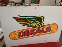 Double sided metal DeKalb sign has some dents