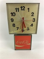 Coca-cola clock comes on.