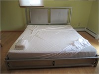 King size bed with metal headboard and mattress.