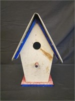 Wooden bird house with tag