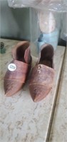 Antique carved wooden shoes and baby shoes