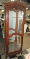 Wood china hutch lighted with glass shelves.