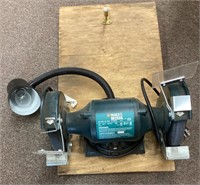 Black & Decker shop grinder mounted on a board