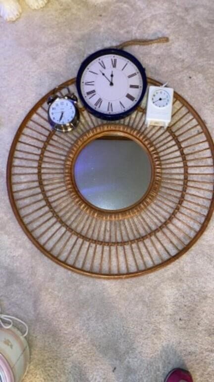 Group of clocks and 24in woven framed mirror