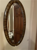 Oval bubble glass wall mirror measuring 44 inches