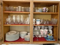 Cupboard full of miscellaneous dishes plates cups