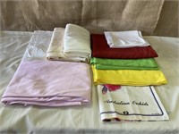 Assorted sizes, assorted colors table cloths.