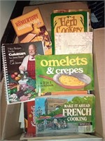 Box of cookbooks and aprons