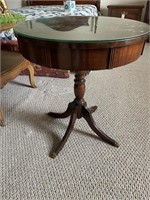 Drum top table with brass claw feet and glass top