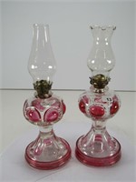TRAY: 2- RED/CLEAR GLASS PEDESTAL OIL LAMPS