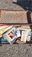 Vintage suitcase with assorted advertising and