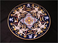 17 3/4" china charger with four pairs of cherubs,