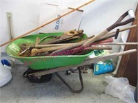 green wheel barrow & old yard tools