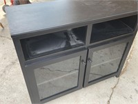 Nice tv stand with glass doors. Measures 42” x