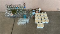 Assortment of glass bottles and cups.