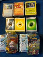 Approx 350 Pokemon cards in tins and glass cases,