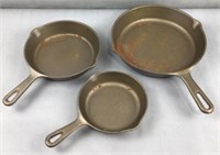 3 unmarked unseasoned cast iron skillets