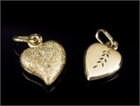 Two 9ct yellow gold night & day heart charms