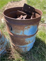 Metal burn barrel full of steel plates.