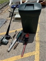 Outdoor hand and power tools and trash can on