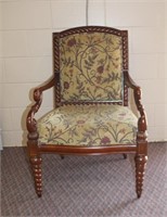 Upholstered arm chair with decorative scroll work