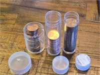 Three partial tubes of pennies