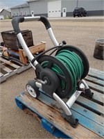 Hose reel on wheels with a garden hose
