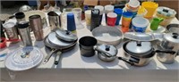 Kitchen supplies including pots pans, lids,