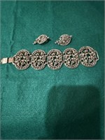 Vintage gold bracelet and matching clip earrings.