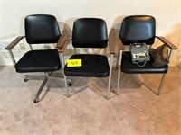 3 office chairs, one has roller wheels