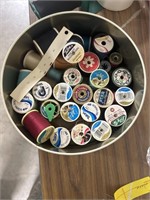 Sewing thread with a metal bear tin