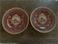 Pair of decorative plates on plate stands - red