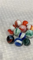 12 Peltier shooter marbles mint.