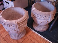 Pair of concrete urns, one has imperfection,