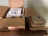 Two stacks of vintage newspapers and magazines