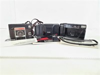 Three vintage cameras with user manuals