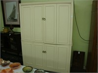 Large cream colored cabinet with shelves.
