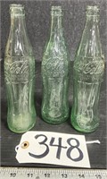 3 Coca-Cola Bottles