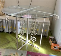 UNUSUAL IRON BASE GLASS TOP TABLE 40" W X 29" H