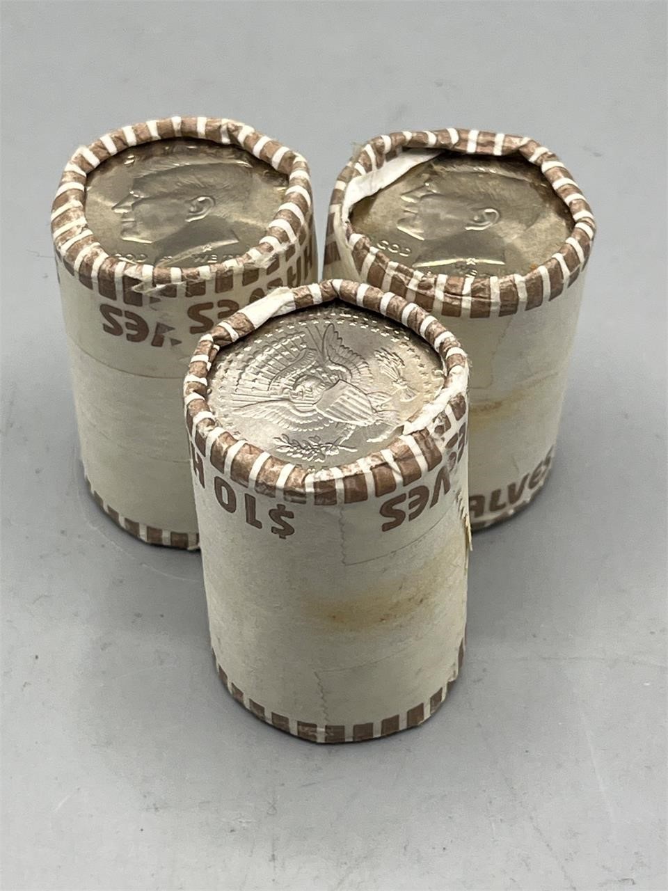 3 U.S. uncirculated Kennedy half dollar coin rolls