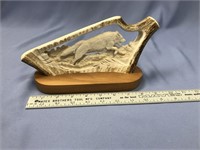 A carved moose antler wolf scene by Dee Connors