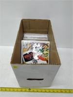 box of comic books in plastic with cardboard