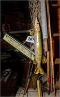 Assortment of fishing poles, fishing sign, netting