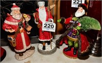 Very cheer trio of Santa figurines, each one