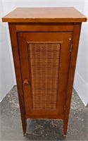 Wood cabinet W/ Wicker front. 13" W x 31" H.