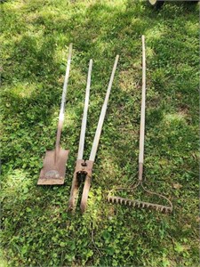 Shovel, post hole diggers and rake