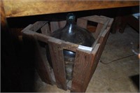 large green wine cask in wooden crate
