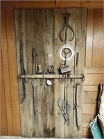 Contents of barn door, antique hand tools, horse