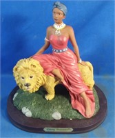 African Woman Sitting on Lion Statue