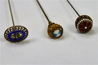 Three Enamelled Hatpins with Fancy Brass Settings